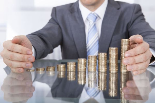 Close-up Of Businessman Protect Stack Of Coins For Business